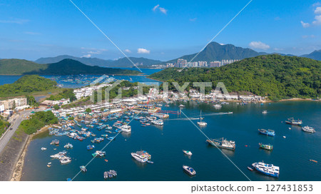 June 7 2025 Harbor View with Boats Docked and Mountainous Background Under Blue Sky June 7 2025 Harbor View with Boats Docked and Mountainous Background Under Blue Sky 127431853