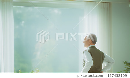 Back view of a senior man looking out the window, copy space available Back view of a senior man looking out the window, copy space available 127432109