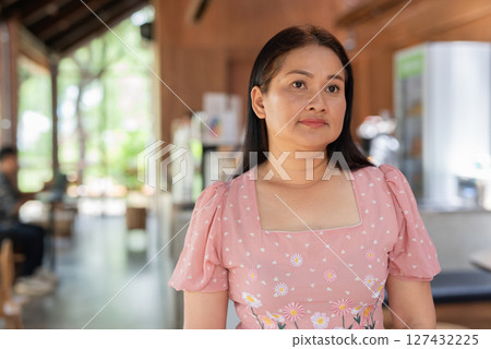 Mature cute Asian woman relaxing in coffee shop 127432225