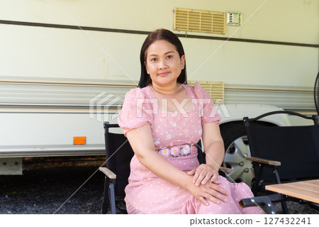 Asian woman enjoying camping and vanlife with recreational trailer Asian woman enjoying camping and vanlife with recreational trailer 127432241