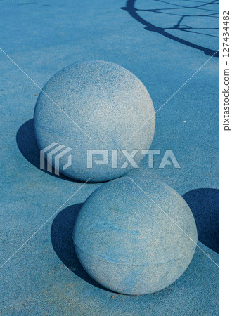 Minimal blue concrete spheres on playground with shadows and geometric texture. High quality photo Minimal blue concrete spheres on playground with shadows and geometric texture. High quality photo 127434482