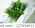 Various herbs wrapped in clean white cloth 127434631