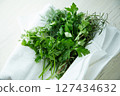 Various herbs wrapped in clean white cloth 127434632