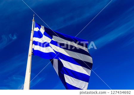 Flag of Greece on flagpole waving in the wind 127434692