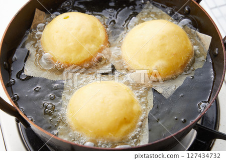 Inside a pan frying donuts 127434732
