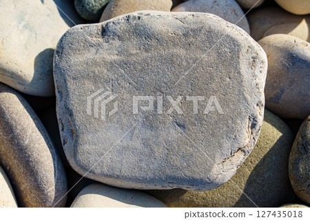 Smooth Beach Stones Natural Textures and Shapes in a Coastal Arrangement. Serenity Found. 127435018