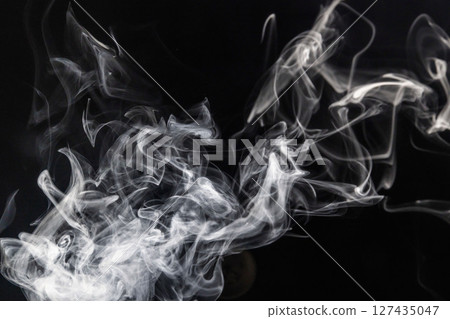 Steam floating in front of a black background 127435047