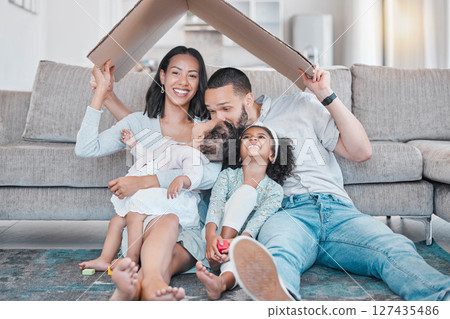 Happy family, cardboard roof or house life insurance in home living room floor in security, mortgage loan success or investment support. Property cover for smile, happy mother or father and children 127435486