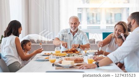 Family, breakfast and food with a senior man eating during a visit from his children and grandchildren at home. Kids, love and celebration with parents and girl siblings enjoying a meal together 127435523