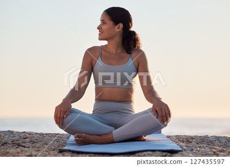 Yoga, meditation or zen exercise black woman relax on yoga mat at beach, sea or ocean for motivation, wellness or workout. Sunset, happy or girl portrait on sand for sport, chakra energy or training 127435597