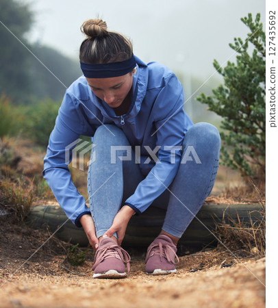 Tired, woman runner with leg pain and ankle injury from an active running marathon race training. Cardio fitness run workout, outdoor exercise and girl sports athlete rest on ground outside in nature Tired, woman runner with leg pain and ankle injury from an active running marathon race training. Cardio fitness run workout, outdoor exercise and girl sports athlete rest on ground outside in nature 127435692
