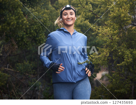Woman, hiking and portrait in forest with smile for fitness, health and wellness with happiness by trees. Girl, happy and woods hiker in nature for exercise, workout and training on travel in summer 127435693
