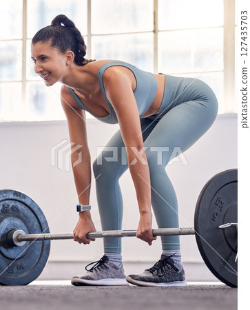 Bodybuilder, strong and weightlifting with woman and fitness in gym, exercise and weights workout routine for muscle and power. Bodybuilding, body training and endurance for health and wellness. 127435703
