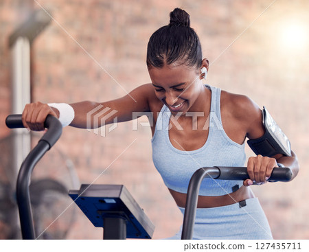 Fitness, woman and intense cycling at the gym for exercise, workout or healthy cardio training. Active female exercising on stationary bicycle or machine for health, wellness and endurance indoors 127435711