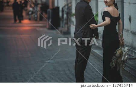 Date, man and woman in black dresses walking in the city at night, couple, bride and groom (dressed up) 127435714