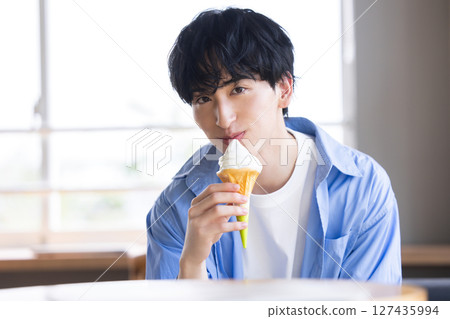 man eating soft serve ice cream 127435994