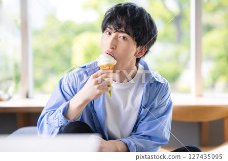 man eating soft serve ice cream man eating soft serve ice cream 127435995