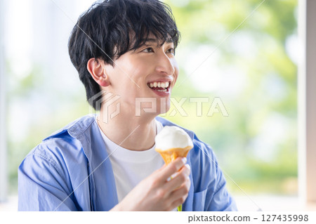man eating soft serve ice cream 127435998