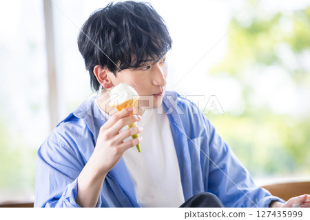 man eating soft serve ice cream 127435999