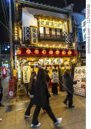 Osaka, Japan - Dec 30, 2022 : Vibrant night view of Janjan Yokocho Alley or Nanyodori Shotengai in Osaka, Japan on Dec 30, 2022. 127436036