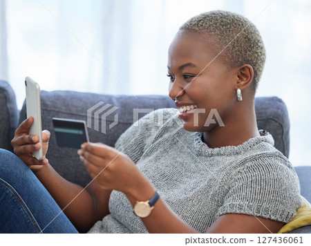 Ecommerce, phone and happy black woman with a credit card online shopping on a digital payment app at home. Smile, banking and excited African girl checks cash budget, money growth or savings online 127436061