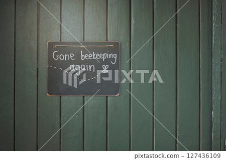 Door, sign and beekeeping with a chalkboard hanging on an entrance way of a small business in agriculture. Wood, store and retail with a notice on a wooden surface for farming or sustainability Door, sign and beekeeping with a chalkboard hanging on an entrance way of a small business in agriculture. Wood, store and retail with a notice on a wooden surface for farming or sustainability 127436109
