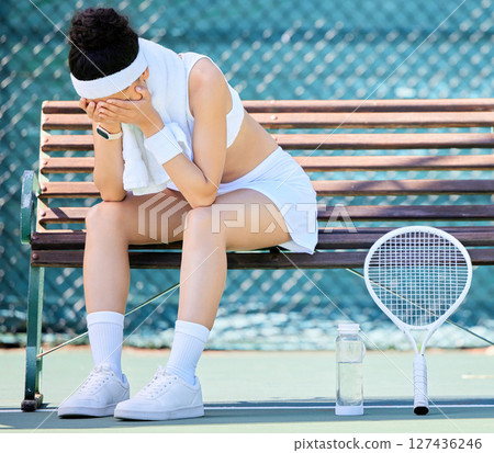 Tired, crying and tennis player with fail in a competition, depression from training stress and mistake in sports. Anxiety, fitness and athlete sad on a tennis court in fear of losing in a game 127436246