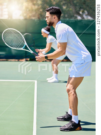 Fitness, teamwork and couple in a tennis partnership for a doubles workout game or training match in summer. Wellness, focus and healthy man playing on a tennis court outdoors with a sports partner Fitness, teamwork and couple in a tennis partnership for a doubles workout game or training match in summer. Wellness, focus and healthy man playing on a tennis court outdoors with a sports partner 127436258