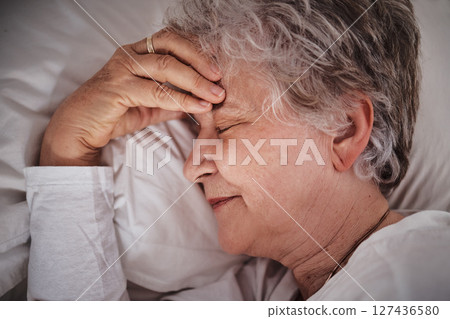 Sleep, headache and senior woman in a bed with stress, anxiety and tired. Sick, sad and face of an elderly lady dreaming with depression and sleeping in her bedroom for rest during retirement Sleep, headache and senior woman in a bed with stress, anxiety and tired. Sick, sad and face of an elderly lady dreaming with depression and sleeping in her bedroom for rest during retirement 127436580