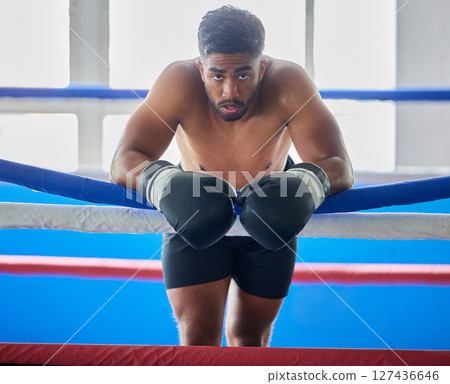 Boxing ring, man and tired from fight, training and workout in gym exercise, burnout and fail in competition games. Portrait sweating boxer, athlete and guy, break and breathing in sports arena club Boxing ring, man and tired from fight, training and workout in gym exercise, burnout and fail in competition games. Portrait sweating boxer, athlete and guy, break and breathing in sports arena club 127436646