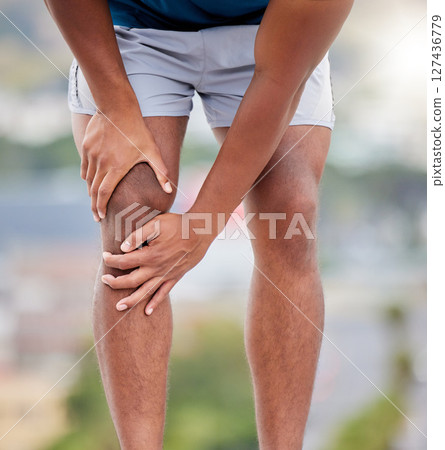 Man, legs and running injury in nature park for wellness exercise, medical accident or sports emergency. Black man, athlete and runner knee pain, joint pain or orthopedic arthritis pain in outdoors 127436779