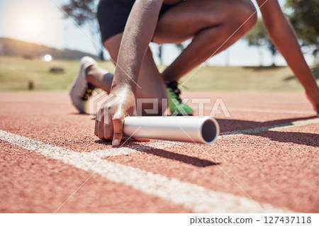 Stadium, running sports and relay athlete on start track ready for race. Fitness, athletics and black woman with baton preparing for sprint, exercise and workout training for competition outdoors. Stadium, running sports and relay athlete on start track ready for race. Fitness, athletics and black woman with baton preparing for sprint, exercise and workout training for competition outdoors. 127437118