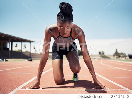 Black woman, runner and start line, race and competition, exercise challenge or fitness at stadium arena. Portrait, focus and sports athlete ready on running track, marathon training and cardio power 127437130
