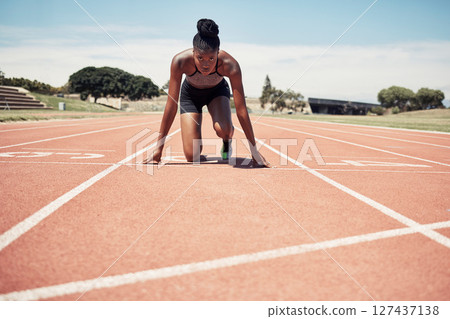 Fitness, running and woman at start line training for marathon race event at stadium. Exercise, sports and motivation for winning, black woman runner from Jamaica ready to run with focus and energy. 127437138