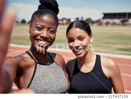Friends, selfie and running with women on stadium track for training, sprinting and stamina endurance. Cardio, workout and sports with portrait of runner for teamwork, collaboration and sprinting 127437139