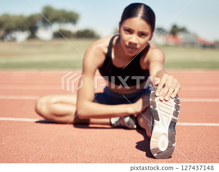 Stretching, feet and sports woman at stadium or race track with fitness training, workout and exercise goals for legs, muscle and body. Athlete or runner warm up on ground for a marathon competition Stretching, feet and sports woman at stadium or race track with fitness training, workout and exercise goals for legs, muscle and body. Athlete or runner warm up on ground for a marathon competition 127437148