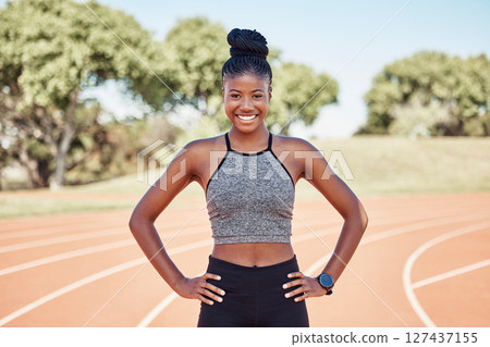 Portrait, black woman and athlete with smile, outdoor and health for wellness, workout and happy on track field. Runner, African American female and confident girl for training, exercise and fitness. Portrait, black woman and athlete with smile, outdoor and health for wellness, workout and happy on track field. Runner, African American female and confident girl for training, exercise and fitness. 127437155