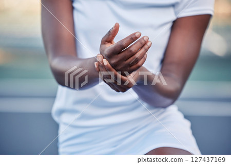 Tennis, sport and hand injury, pain and black woman hurt during game, fitness and exercise with sports accident and emergency. Athlete sprain, inflammation and medical care with training and active. 127437169