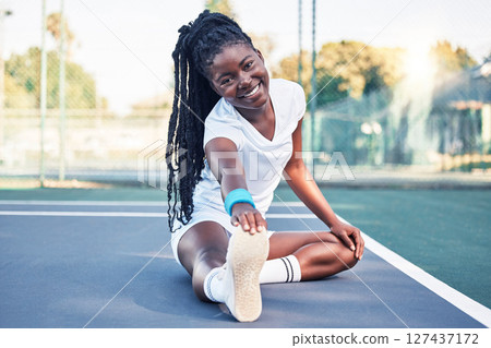 Tennis, fitness and stretching woman on floor in sports court for health, wellness and competition training in happy portrait. African athlete ground warm up or exercise for muscle, energy and legs Tennis, fitness and stretching woman on floor in sports court for health, wellness and competition training in happy portrait. African athlete ground warm up or exercise for muscle, energy and legs 127437172