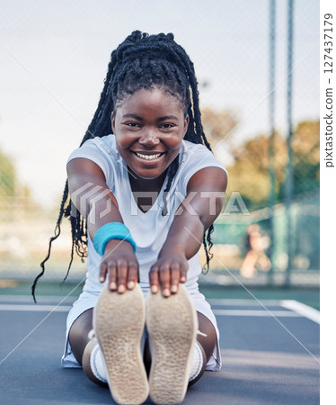 Black woman, fitness and stretching legs for sports exercise, training or workout preparation in the outdoors. Portrait of African American female with smile for warm up leg and arm stretch on floor 127437179