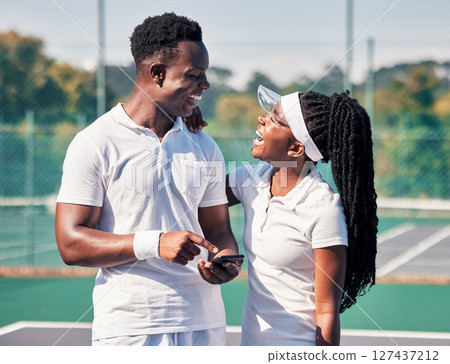 Black couple, tennis and phone, laughing or smile for online communication or social media fitness. African man, woman and happy tennis player streaming comic video or workout motivation on court 127437212