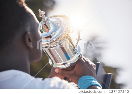 Trophy, winner and black man with sports achievement, goal and success on sky mockup and sunshine for champion reward. Competition, winning and athlete with prize, fitness celebration and game event 127437240