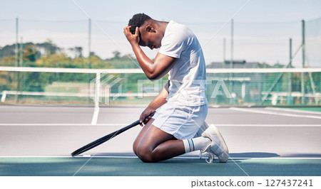 Tennis court, mistake and black man with depression, stress and mental health problem of anxiety after sports training, workout and exercise. Athlete model sad after loss, failure and burnout outdoor Tennis court, mistake and black man with depression, stress and mental health problem of anxiety after sports training, workout and exercise. Athlete model sad after loss, failure and burnout outdoor 127437241