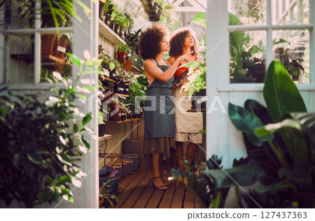 Tablet, plants and women, florist shop and nature in retail store, service and eco friendly market. Female seller staff check flowers, leaves and digital planning for sustainable startup management 127437363