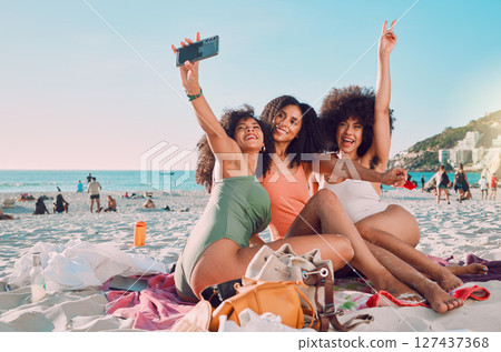 Phone, selfie and women friends on the beach with freedom on a summer adventure on vacation in Mexico. Travel, happiness and girls taking a picture on seaside holiday or journey by the ocean together 127437368