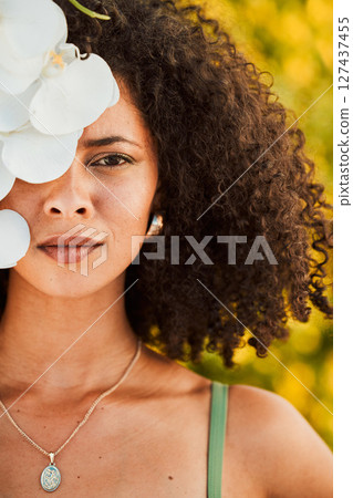 Black woman, beauty and orchid flower outdoor in nature for cosmetic, makeup and natural dermatology product. Face of aesthetic model with natural plant skincare, health and fashion vacation portrait Black woman, beauty and orchid flower outdoor in nature for cosmetic, makeup and natural dermatology product. Face of aesthetic model with natural plant skincare, health and fashion vacation portrait 127437455