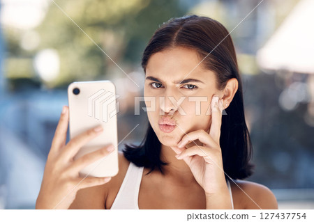 Woman, phone selfie and funny face, portrait and picture for online, social media or internet post in the morning in home. Gen z girl, picture and facial expression with 5g mobile smartphone in house 127437754