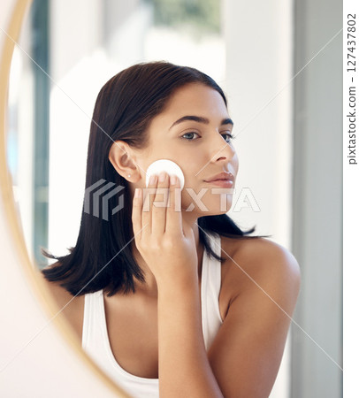 Beauty, mirror reflection and woman with cotton pad for facial cleaning, makeup removal or home skincare routine. Health, wellness or face of model girl with cosmetics product for self care treatment Beauty, mirror reflection and woman with cotton pad for facial cleaning, makeup removal or home skincare routine. Health, wellness or face of model girl with cosmetics product for self care treatment 127437802