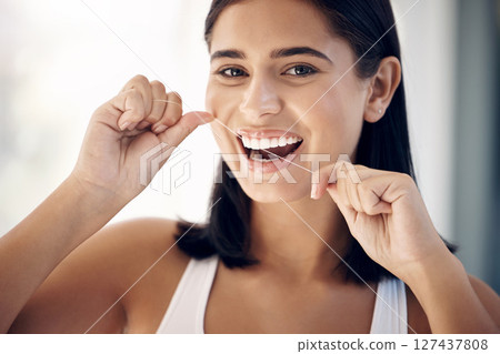 Floss, teeth and dental with woman in bathroom for morning routine, oral hygiene and healthy gums. Wellness, cleaning and mouth with portrait of girl and big smile at home for cavity and toothcare 127437808