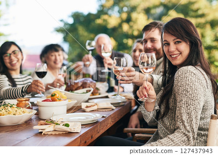 Family, portrait and wine toast, food and thanksgiving meal on patio by happy, smile and relax people. Happy family, cheers and buffet lunch celebration of tradition, holiday and social gathering 127437943
